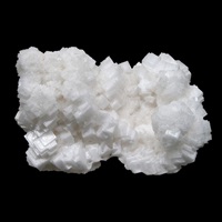An image of a cluster of halite crystals on a black background.