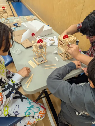 Students building small wind-powered models.