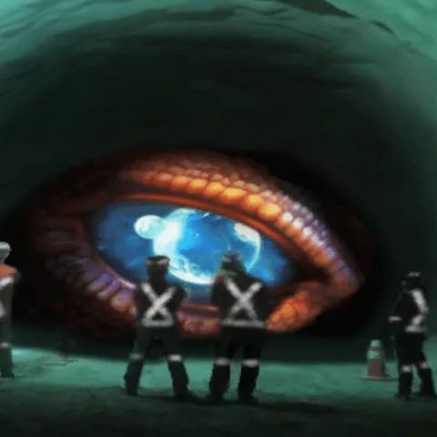 L'œil d'un dragon observant plusieurs personnes vêtues d'EPI dans un tunnel minier.