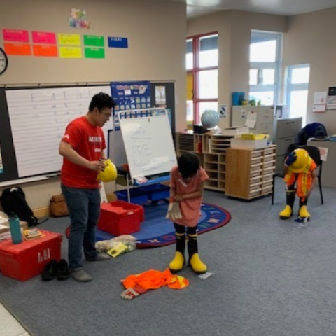Mining Matters staff facilitating a hands-on PPE activity with students at Henry Coaster Memorial School during a previous Mining Rocks partnership program in 2023.